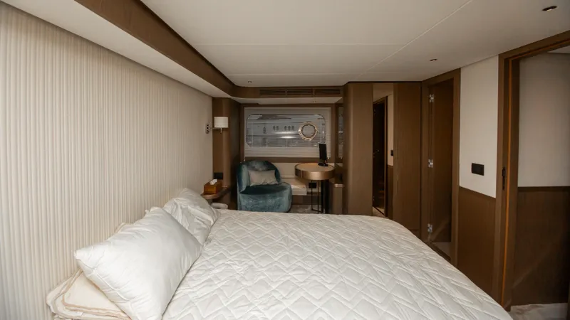  Yacht Photos Pics Luxurious bedroom interior of 2024 Azimut Magellano 66 yacht, featuring elegant furnishings and modern design.