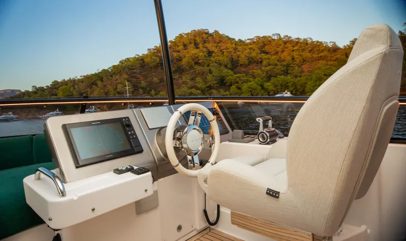 Yacht Photos Pics Helm of 2024 Azimut Magellano 66 yacht with modern controls and scenic view.
