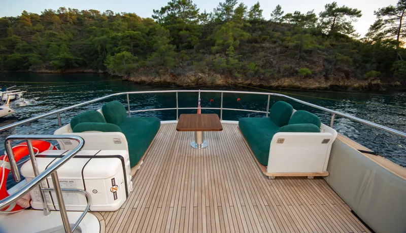  Yacht Photos Pics Luxurious deck of 2024 Azimut Magellano 66 yacht with seating, table, and scenic water view.