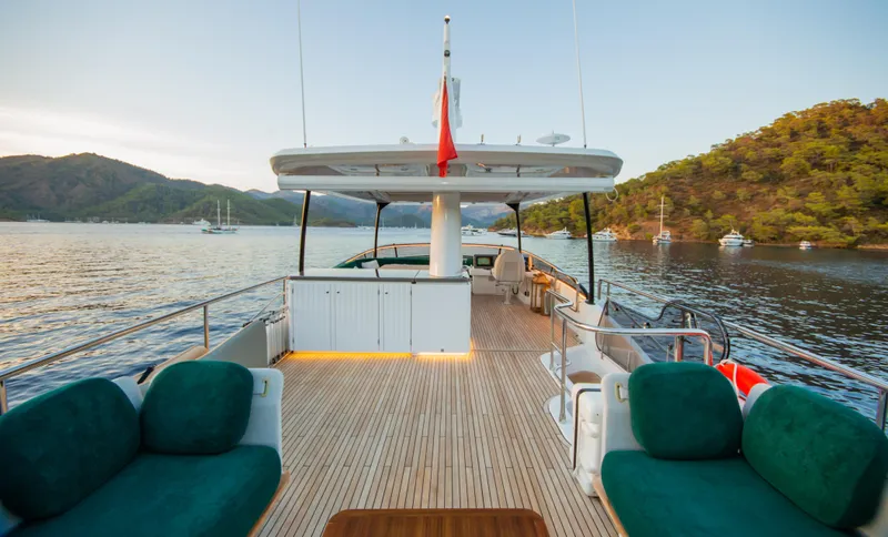  Yacht Photos Pics Luxurious 2024 Azimut Magellano 66 yacht deck with scenic coastal view.