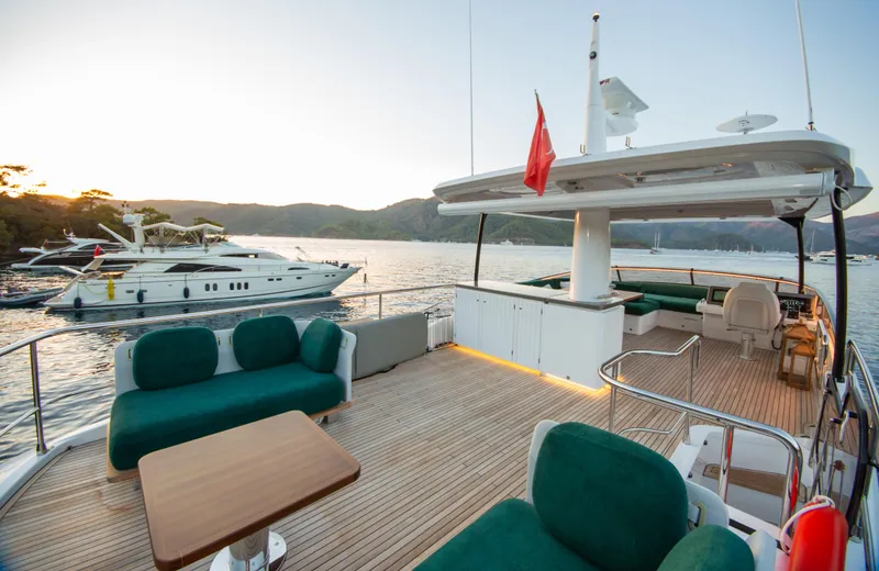  Yacht Photos Pics Luxurious 2024 Azimut Magellano 66 yacht deck with elegant seating and scenic ocean view.