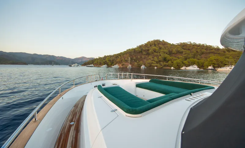  Yacht Photos Pics 2024 Azimut Magellano 66 yacht with scenic coastal view and luxurious deck seating.