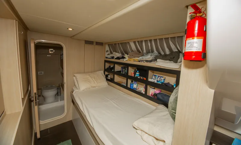  Yacht Photos Pics 2024 Azimut Magellano 66 cabin interior with bed, shelves, and bathroom.