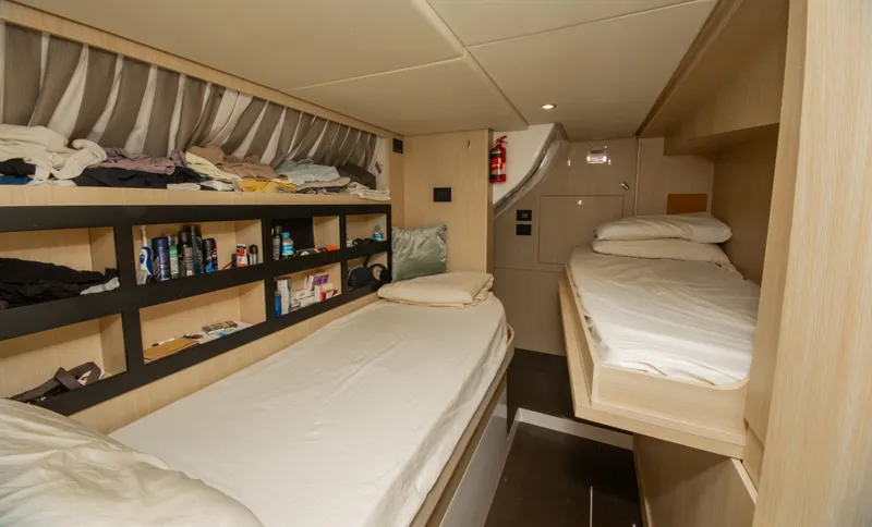  Yacht Photos Pics Cabin interior of 2024 Azimut Magellano 66 yacht with twin beds and storage shelves.