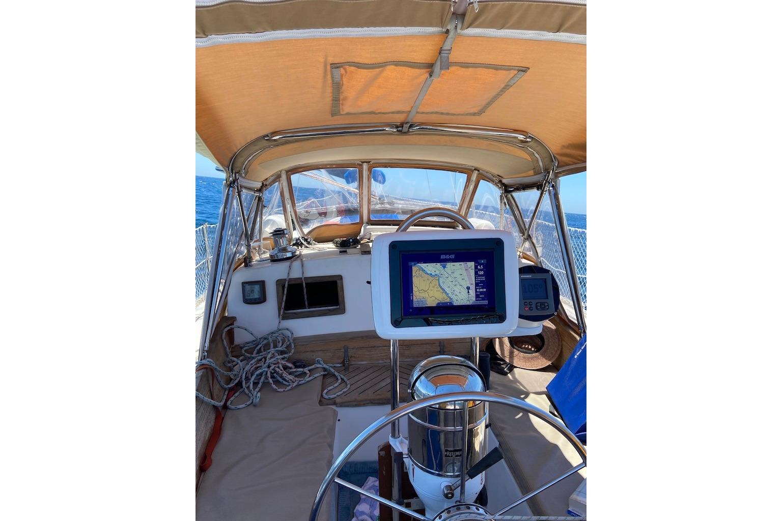 Cockpit of 1988 Reliance 44 sailboat with navigation equipment and ocean view.
