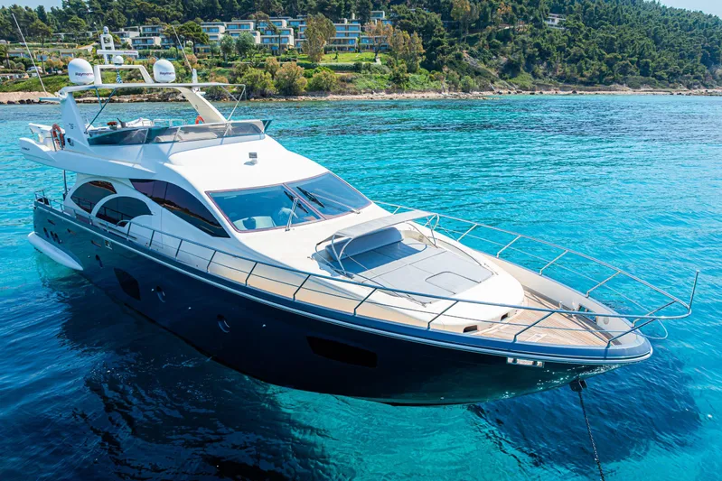 Vea Yacht Photos Pics Luxury 2008 Azimut 75 yacht on clear blue water near a scenic coastline.