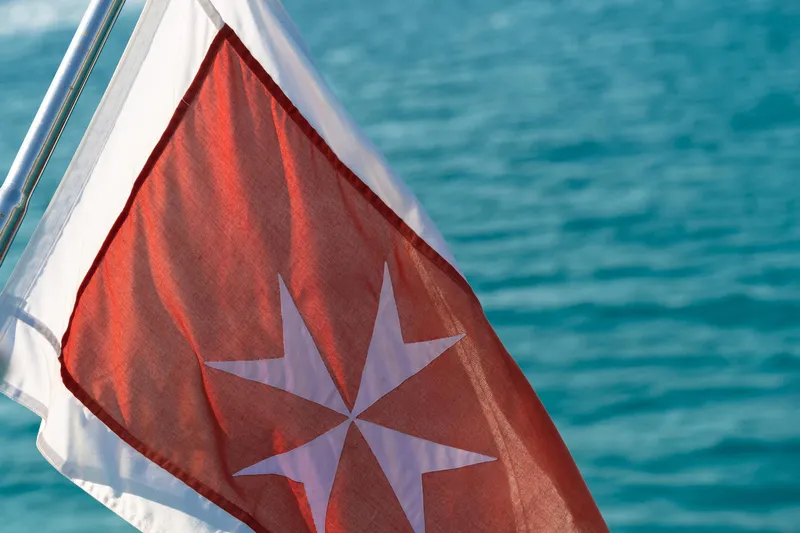 Vea Yacht Photos Pics Red flag with white cross on Azimut 75 yacht, 2008, against blue sea background.