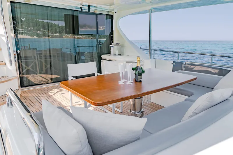 Vea Yacht Photos Pics Luxurious 2008 Azimut 75 yacht deck with elegant seating, table, and ocean view.