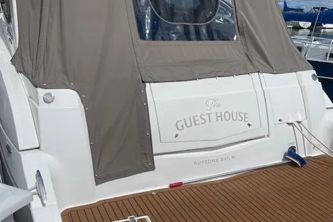  Yacht Photos Pics 2011 Cruisers Yachts 360 Express docked, featuring "The Guest House" nameplate, Suttons Bay, MI.