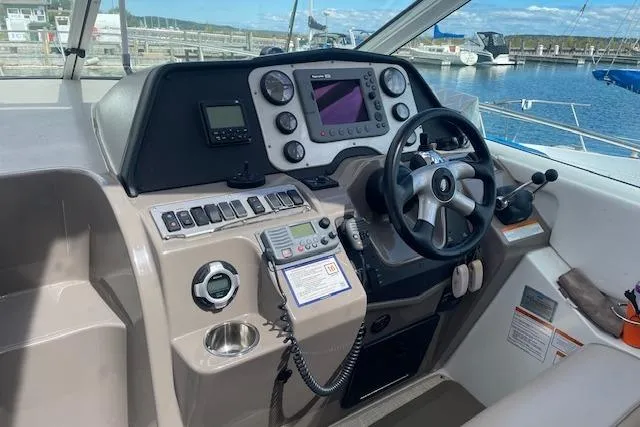  Yacht Photos Pics 2011 Cruisers Yachts 360 Express helm with navigation controls and steering wheel.