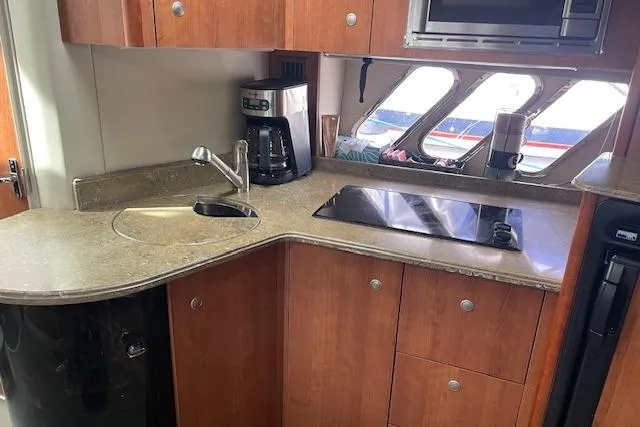  Yacht Photos Pics 2011 Cruisers Yachts 360 Express kitchen with sink, stove, and coffee maker.