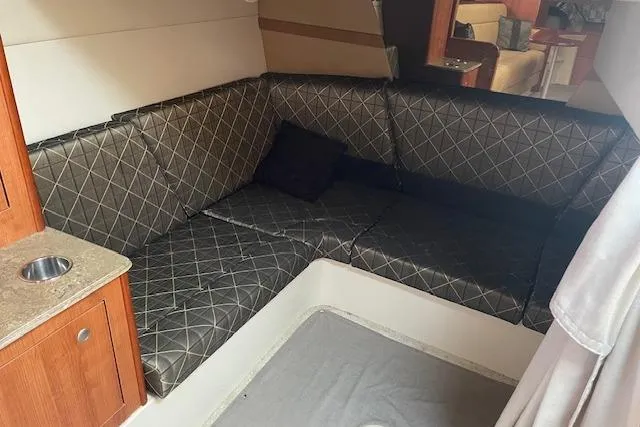  Yacht Photos Pics Interior of 2011 Cruisers Yachts 360 Express with cushioned seating and wooden cabinetry.