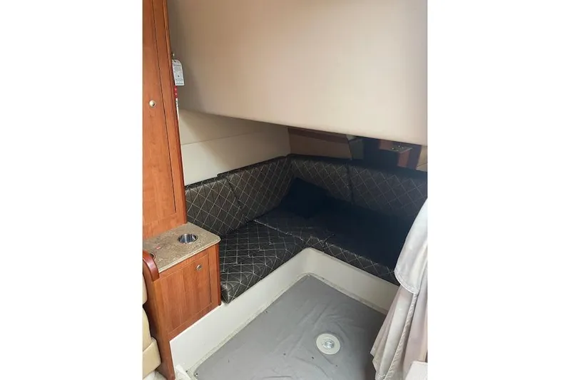  Yacht Photos Pics 2011 Cruisers Yachts 360 Express cabin interior with cushioned seating and wooden cabinetry.