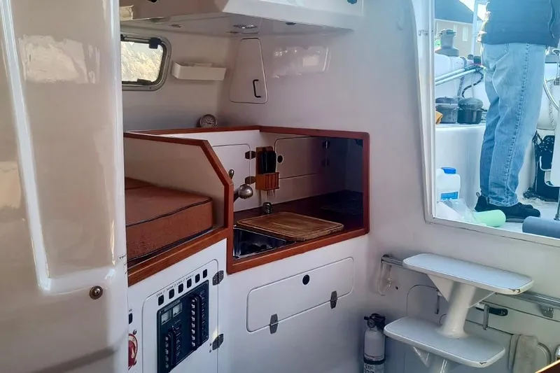 Wingnut Yacht Photos Pics Interior of a 2012 Hughes 40 sailboat featuring a compact kitchen area.