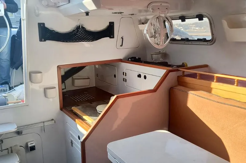 Wingnut Yacht Photos Pics Interior of a 2012 Hughes 40 sailboat featuring a compact kitchen and seating area.