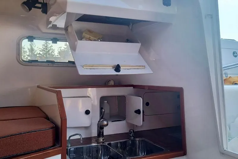 Wingnut Yacht Photos Pics Interior of a 2012 Hughes 40 boat, featuring a compact kitchen with sink and storage.