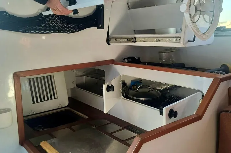 Wingnut Yacht Photos Pics Compact kitchen area in a 2012 Hughes 40 boat, featuring storage and cooking space.
