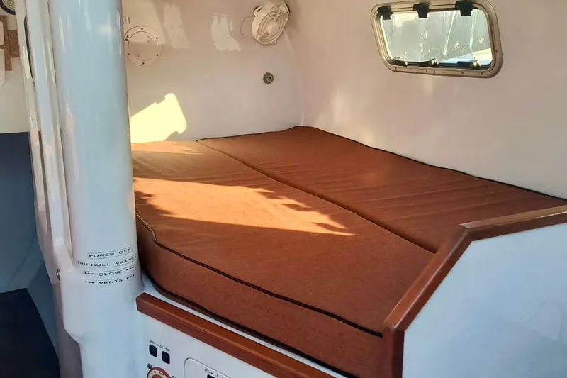 Wingnut Yacht Photos Pics Cozy cabin interior of 2012 Hughes 40 sailboat with brown cushioned bed.