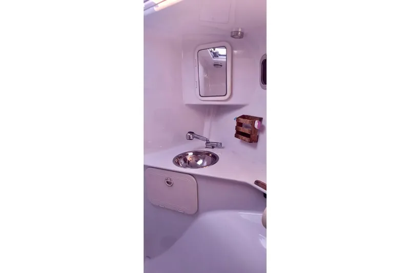 Wingnut Yacht Photos Pics Compact bathroom interior of 2012 Hughes 40 yacht with sink and mirror.