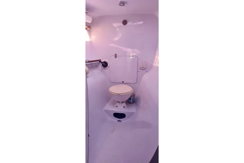 Wingnut Yacht Photos Pics Compact marine bathroom in a 2012 Hughes 40 sailboat, featuring a toilet and storage.
