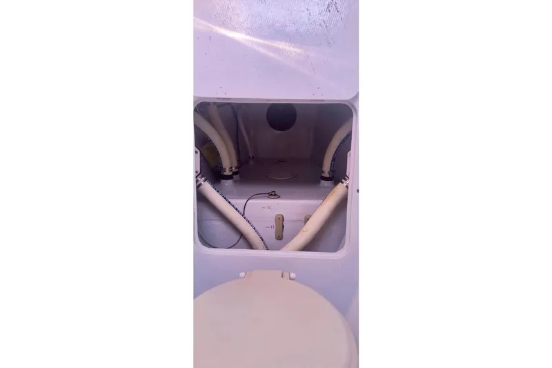 Wingnut Yacht Photos Pics Interior view of a 2012 Hughes 40 boat showing plumbing and storage compartment.