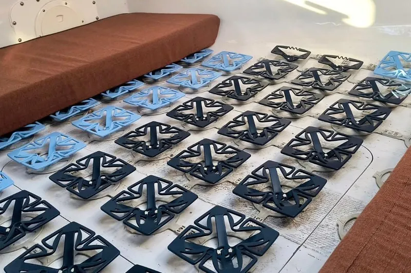 Wingnut Yacht Photos Pics Interior of a 2012 Hughes 40 with grid-like floor structure and brown seating.