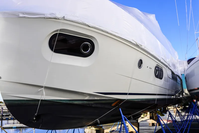 Toot 2 Yacht Photos Pics 2023 Beneteau Swift Trawler 41 Fly yacht in dry dock, partially covered.