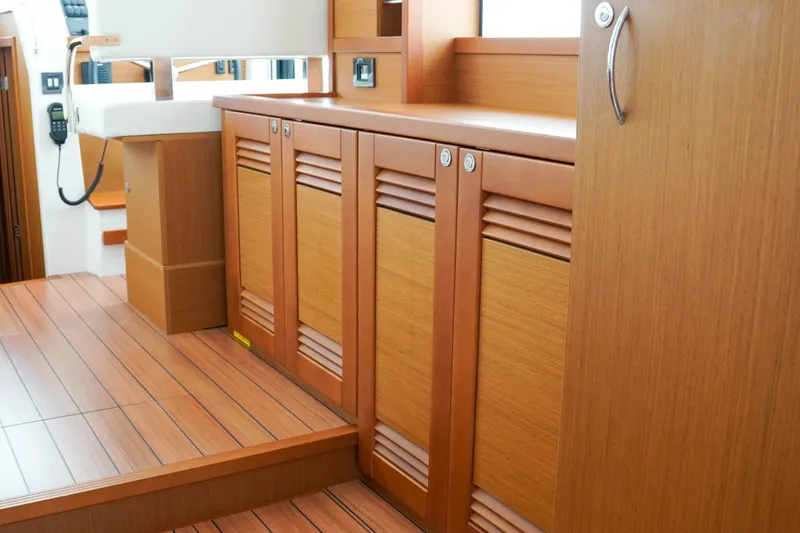 Toot 2 Yacht Photos Pics 2023 Beneteau Swift Trawler 41 Fly interior with wooden cabinetry and flooring.