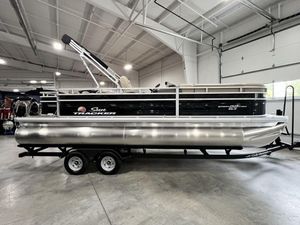 2024 Sun Tracker SportFish™ 22 DLX pontoon boat in a showroom on a trailer.