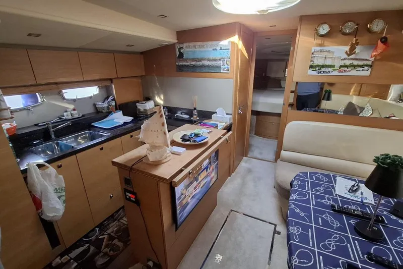  Yacht Photos Pics Interior of 2009 Fairline Targa 52 MK3 yacht with kitchen and seating area.