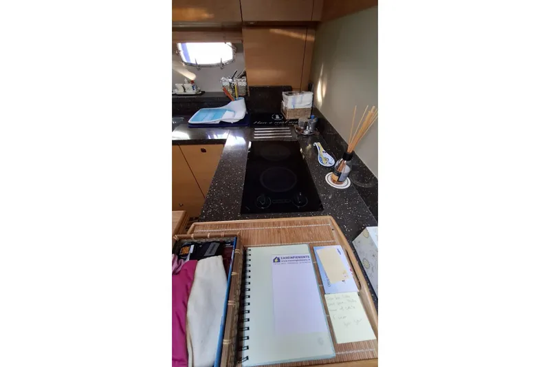  Yacht Photos Pics Interior of 2009 Fairline Targa 52 MK3 yacht kitchen with stove and countertop accessories.