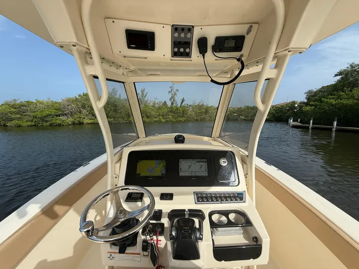  Yacht Photos Pics 2020 Scout 277 LXF boat helm with steering wheel and navigation system.
