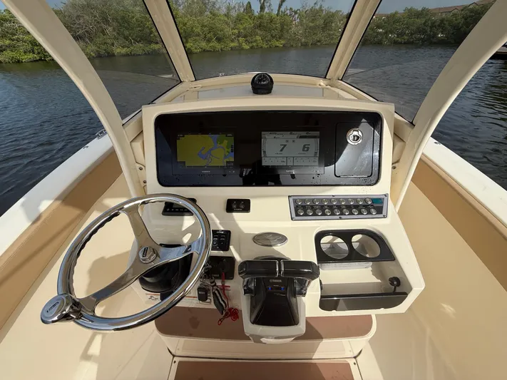 Yacht Photos Pics 2020 Scout 277 LXF boat dashboard with steering wheel and navigation display.