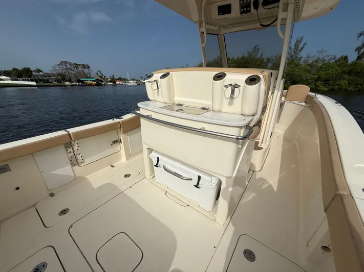  Yacht Photos Pics 2020 Scout 277 LXF boat interior with seating and storage, on a calm waterway.