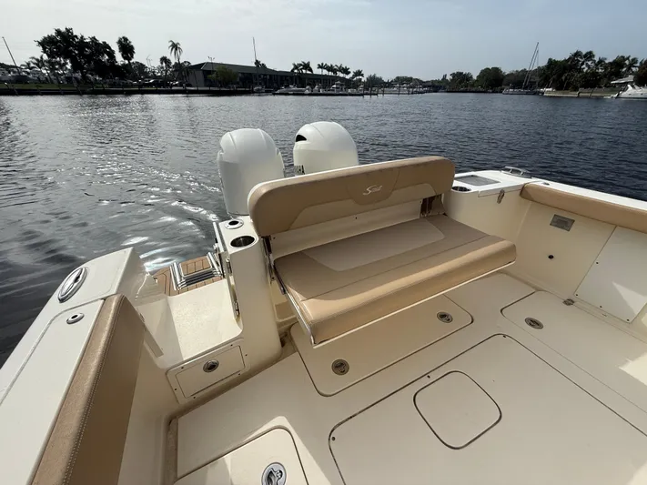  Yacht Photos Pics 2020 Scout 277 LXF boat with beige seating, docked on a calm lake.
