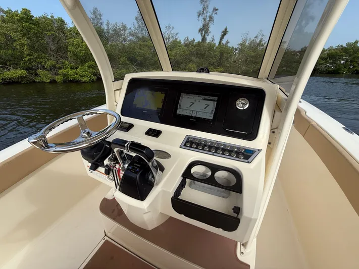  Yacht Photos Pics 2020 Scout 277 LXF boat dashboard with steering wheel and navigation system.