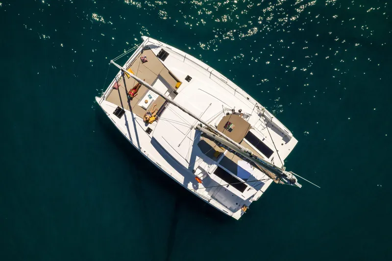  Yacht Photos Pics Aerial view of 2026 Bali 4.2 catamaran sailing on clear blue water.