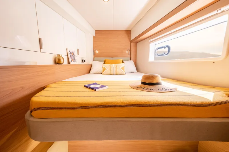  Yacht Photos Pics Luxurious cabin interior of 2026 Bali 4.2 yacht with cozy bed and window view.
