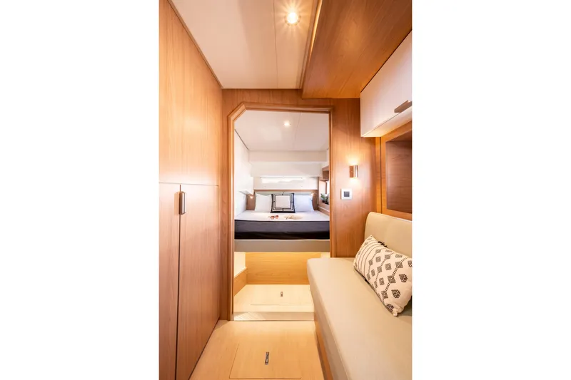  Yacht Photos Pics Luxurious interior of 2026 Bali 4.2 yacht with cozy bedroom and elegant wood finish.