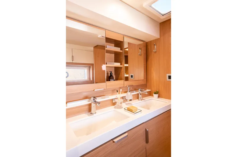  Yacht Photos Pics Modern bathroom interior on Bali 4.2 yacht, featuring dual sinks and wooden cabinetry, 2026 model.
