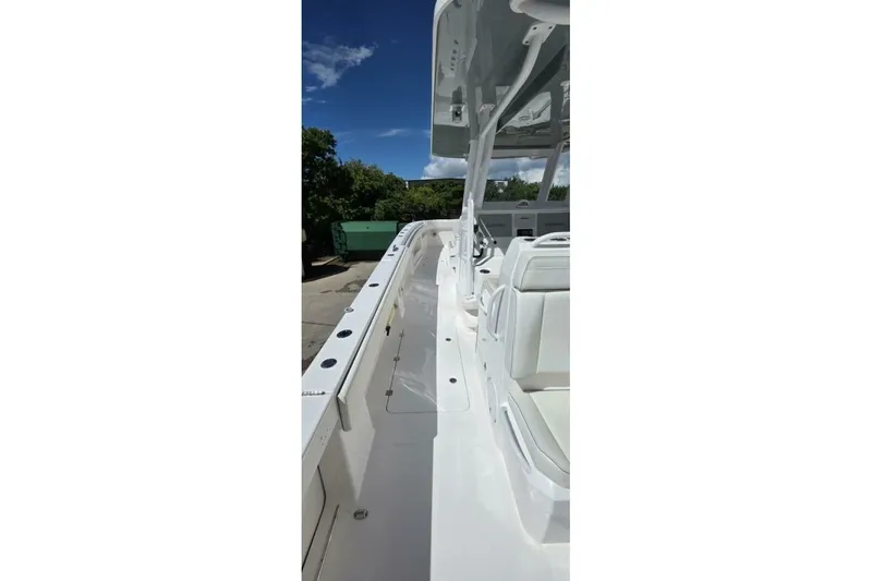 Hit N Run Yacht Photos Pics 2020 Invincible 35 Catamaran with sleek white deck and seating under clear blue sky.