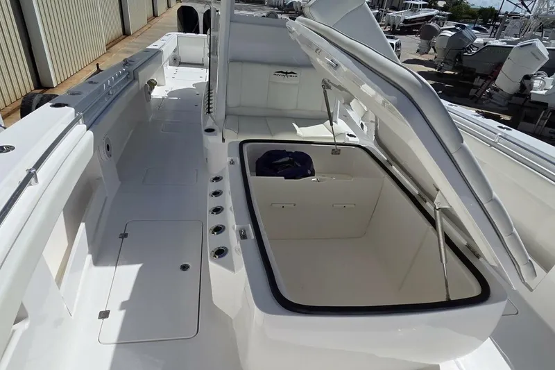 Hit N Run Yacht Photos Pics 2020 Invincible 35 Catamaran with open storage compartment, sleek white deck design.