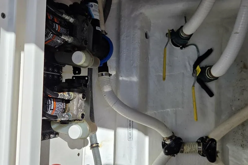 Hit N Run Yacht Photos Pics Engine compartment of 2020 Invincible 35 Catamaran with visible hoses and valves.