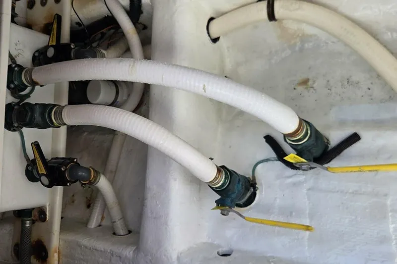 Hit N Run Yacht Photos Pics Engine compartment of 2020 Invincible 35 Catamaran with hoses and valves.