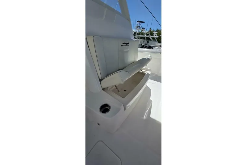Hit N Run Yacht Photos Pics 2020 Invincible 35 Catamaran interior with white seating and storage compartment.