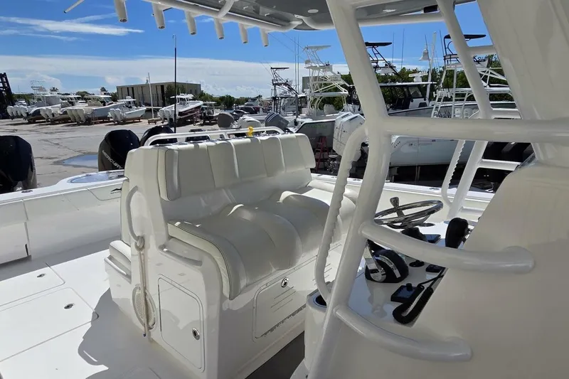 Hit N Run Yacht Photos Pics 2020 Invincible 35 Catamaran interior with white seating and control panel.