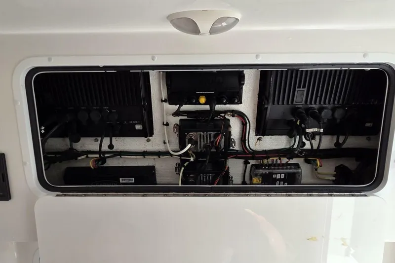 Hit N Run Yacht Photos Pics Electrical panel inside 2020 Invincible 35 Catamaran, showcasing wiring and components.