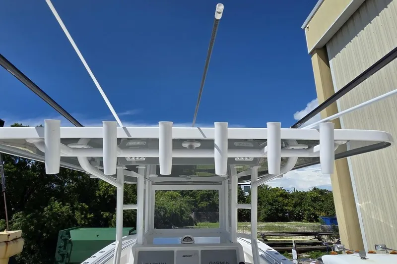 Hit N Run Yacht Photos Pics 2020 Invincible 35 Catamaran with rod holders and Garmin equipment under a clear blue sky.