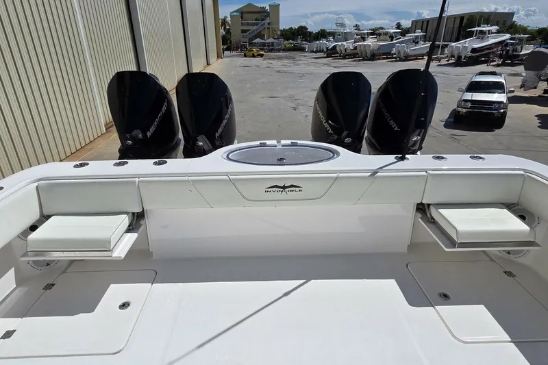 Hit N Run Yacht Photos Pics 2020 Invincible 35 Catamaran with four Mercury outboard engines, docked in a marina.