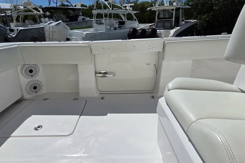 Hit N Run Yacht Photos Pics 2020 Invincible 35 Catamaran interior with white seating and deck, showcasing modern design.
